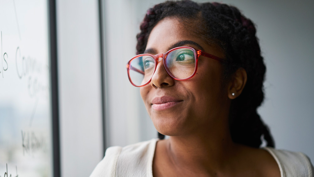 calm and confident woman looking out window