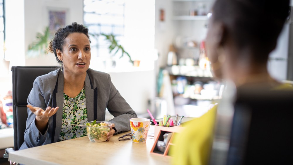 woman showing frustration with boss in office
