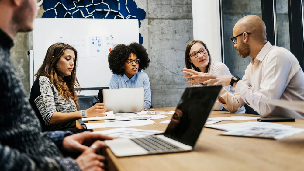 three women and two men in a business meeting