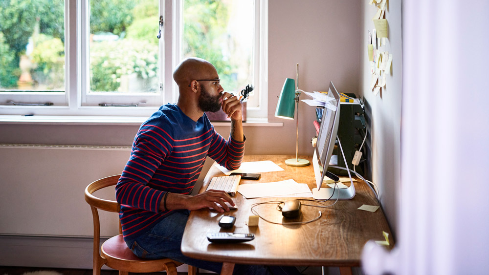 man working at home on computer