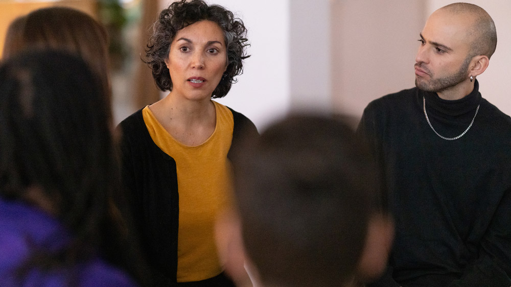 mature woman speaking with a group