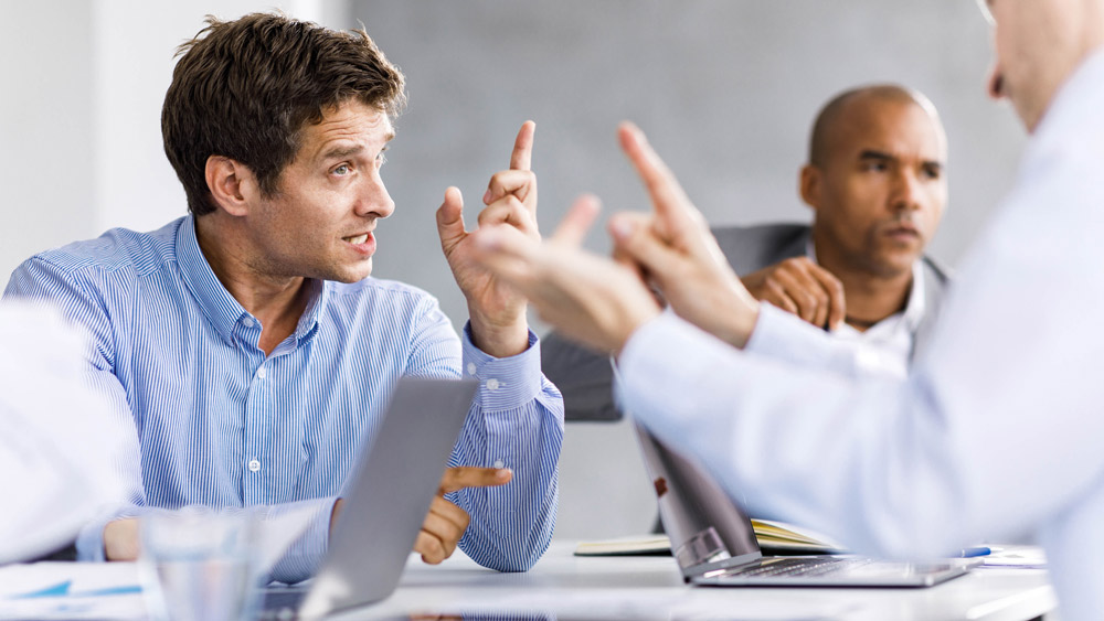 two men arguing in a business meeting