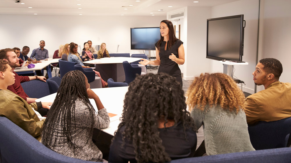 Woman teaching a classroom of adults