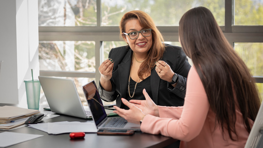 two women talking in office