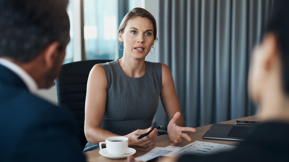 woman talking with coworkers in boardroom