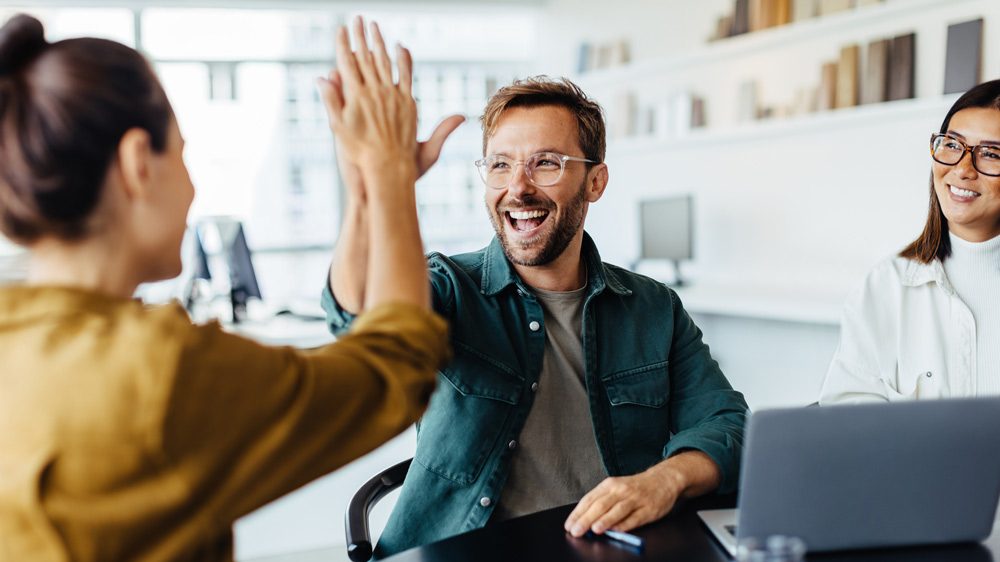 business teammates giving each other high five