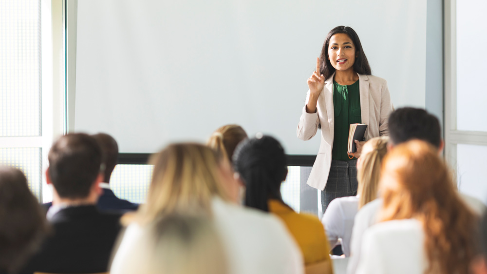 a businesswoman training a group of people