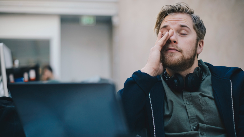 man at work, looking drained and exhausted