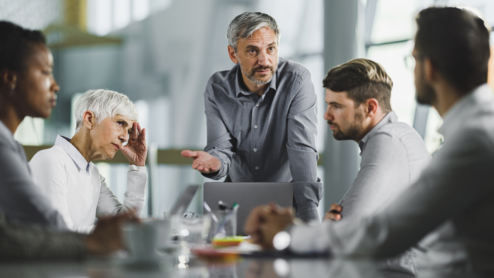 male CEO holding a meeting with his team