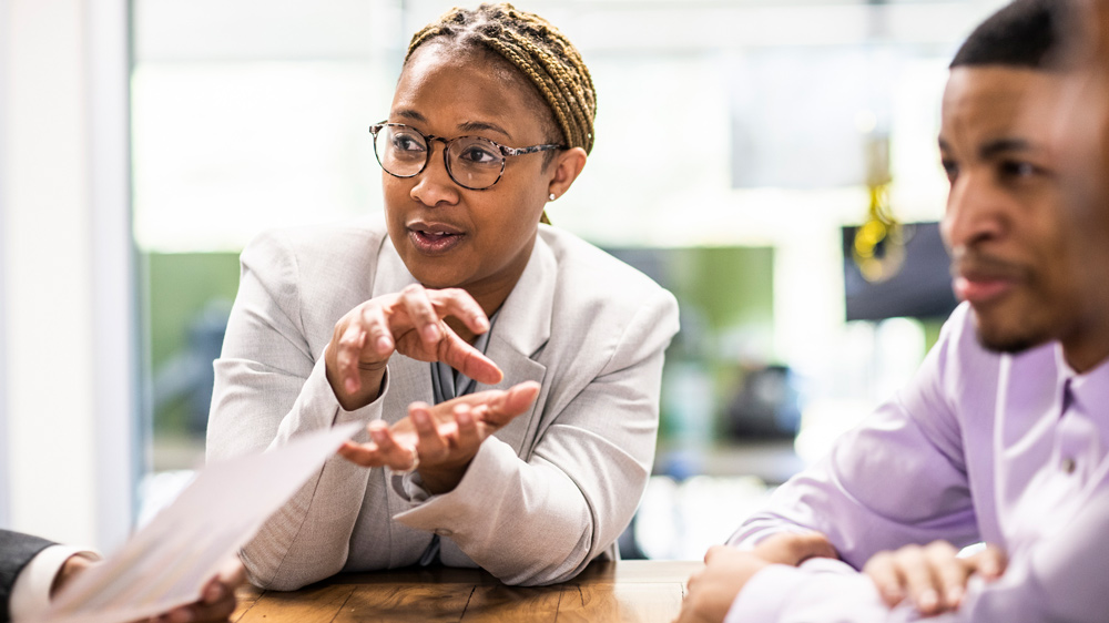 a businesswoman leading an office discussion