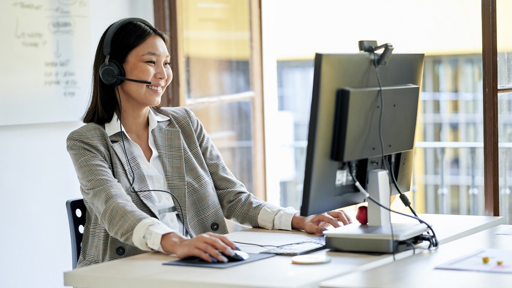 telemarketer workin in office with by the window