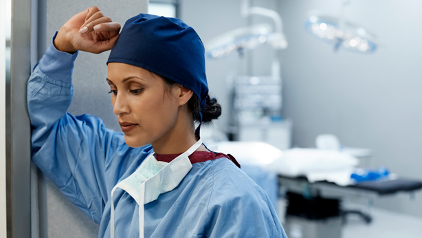 disappointed nurse standing in hospital doorway