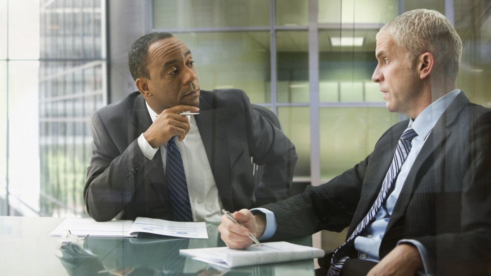 two businessmen having serious conversation