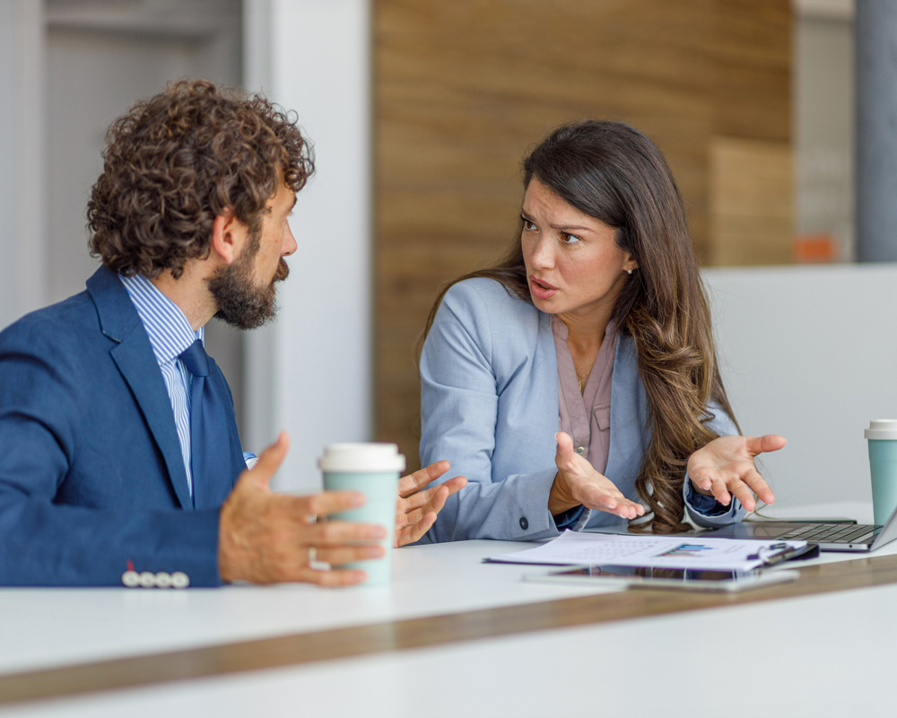 a man and woman, business colleagues, arguing