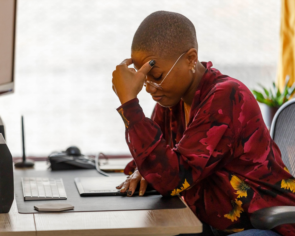 women feeling defeated at her desk
