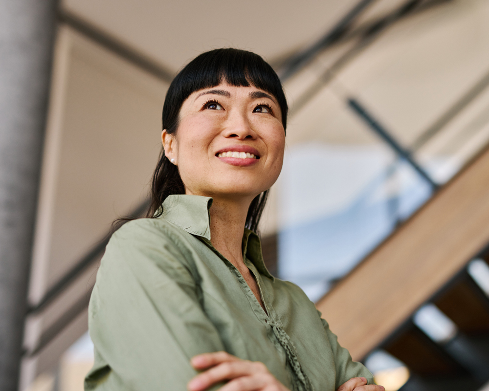 Confident Japanese Businesswoman Smiling in Modern Office Building