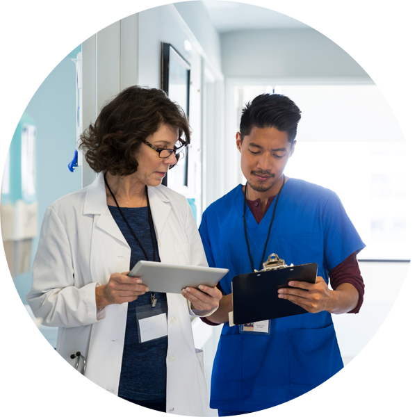 A doctor and nurse having a conversation in a hospital