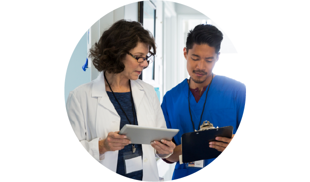 A doctor and nurse having a conversation in a hospital