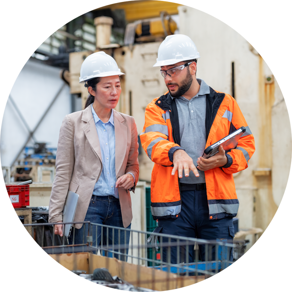 Two colleagues having a conversation in a manufacturing plant