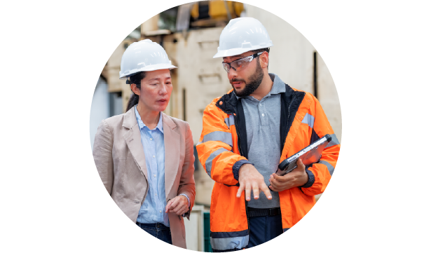 Two colleagues having a conversation in a manufacturing plant